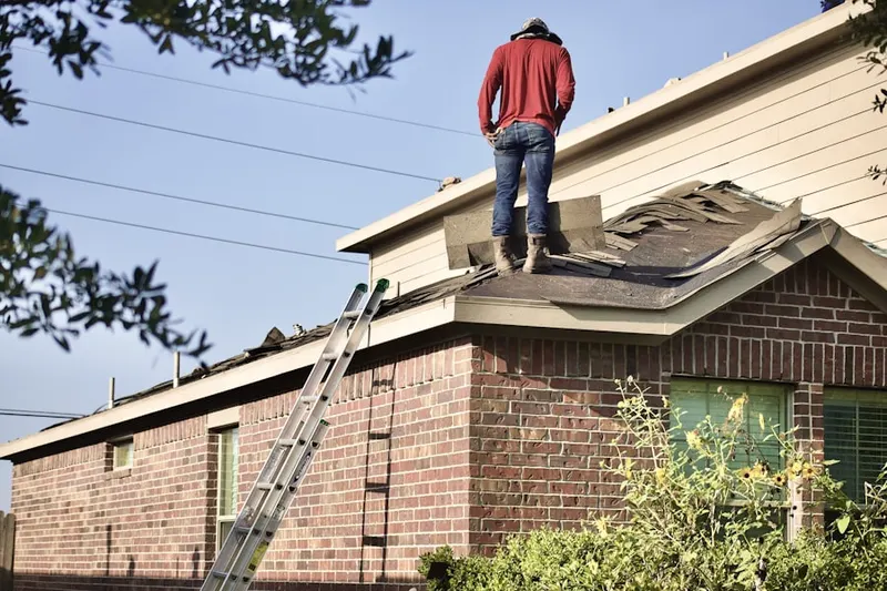 Professional roofer working on a residential roof in Lees Mill